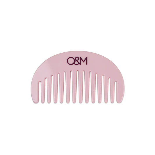 Pink comb with 'O&M' logo on a white background